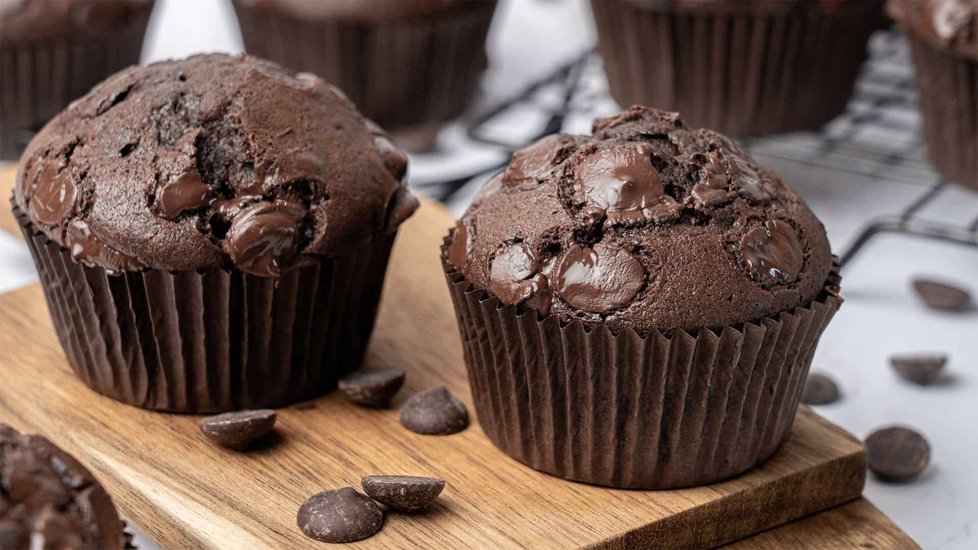 Double chocolate muffins on a cutting board.