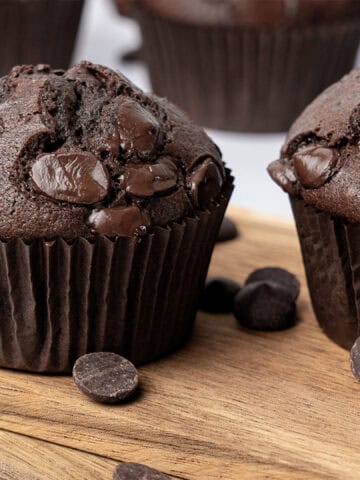 Double chocolate muffins on a cutting board.