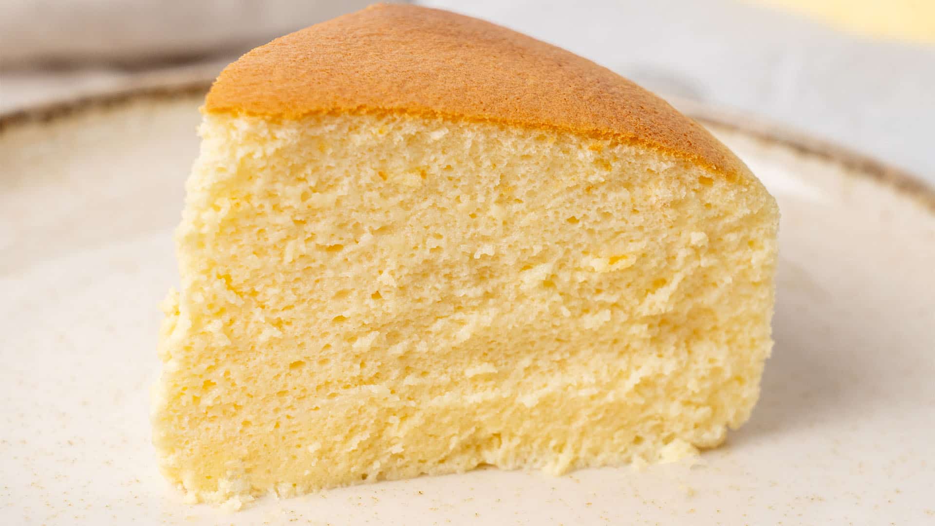 a slice of Japanese cheesecake o na baking paper.