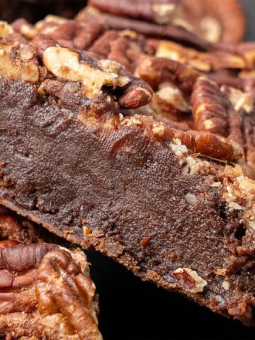 Pecan brownies on a cutting board.