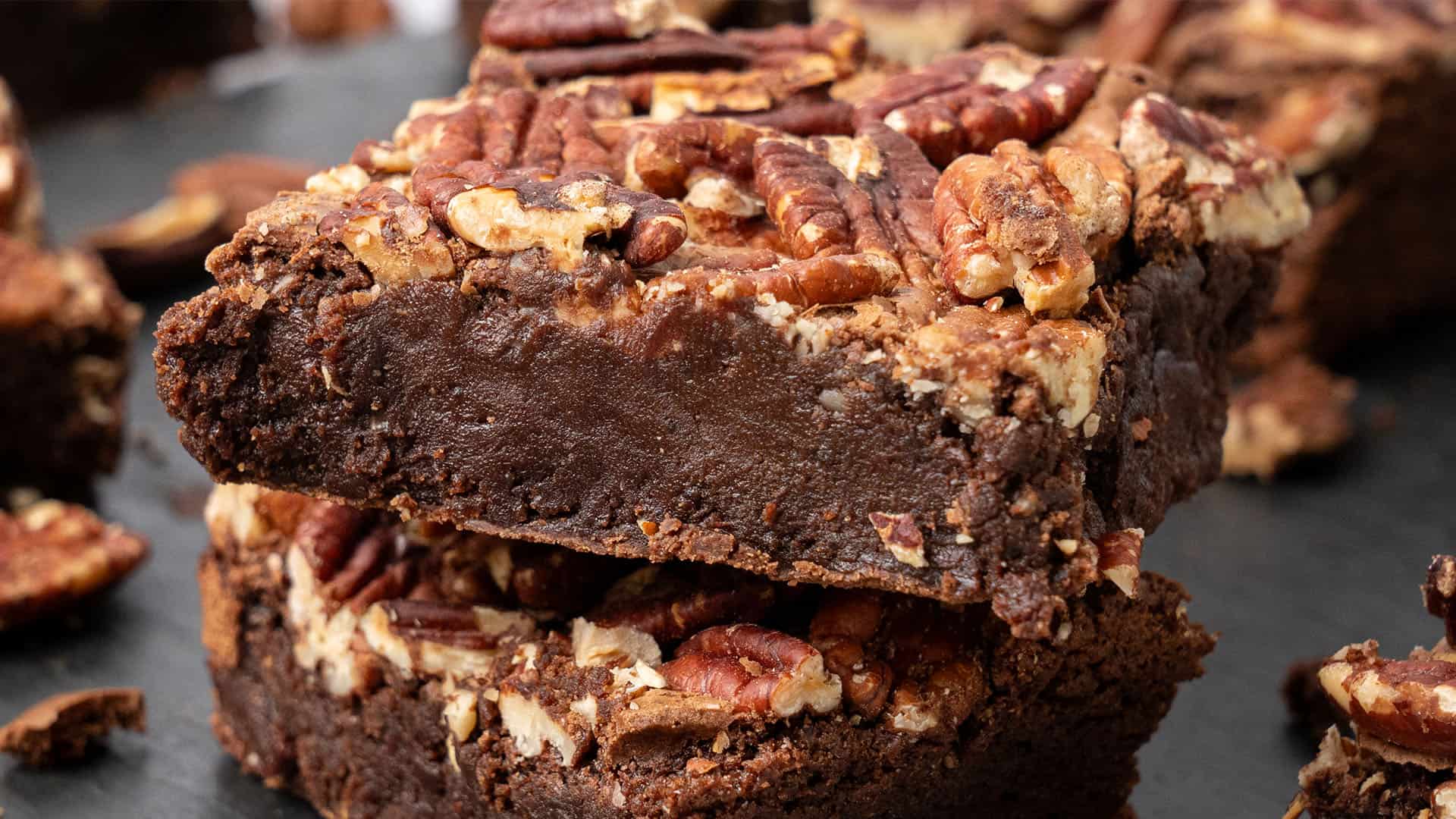 Pecan brownies on a cutting board.
