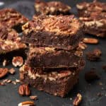Pecan brownies on a cutting board.