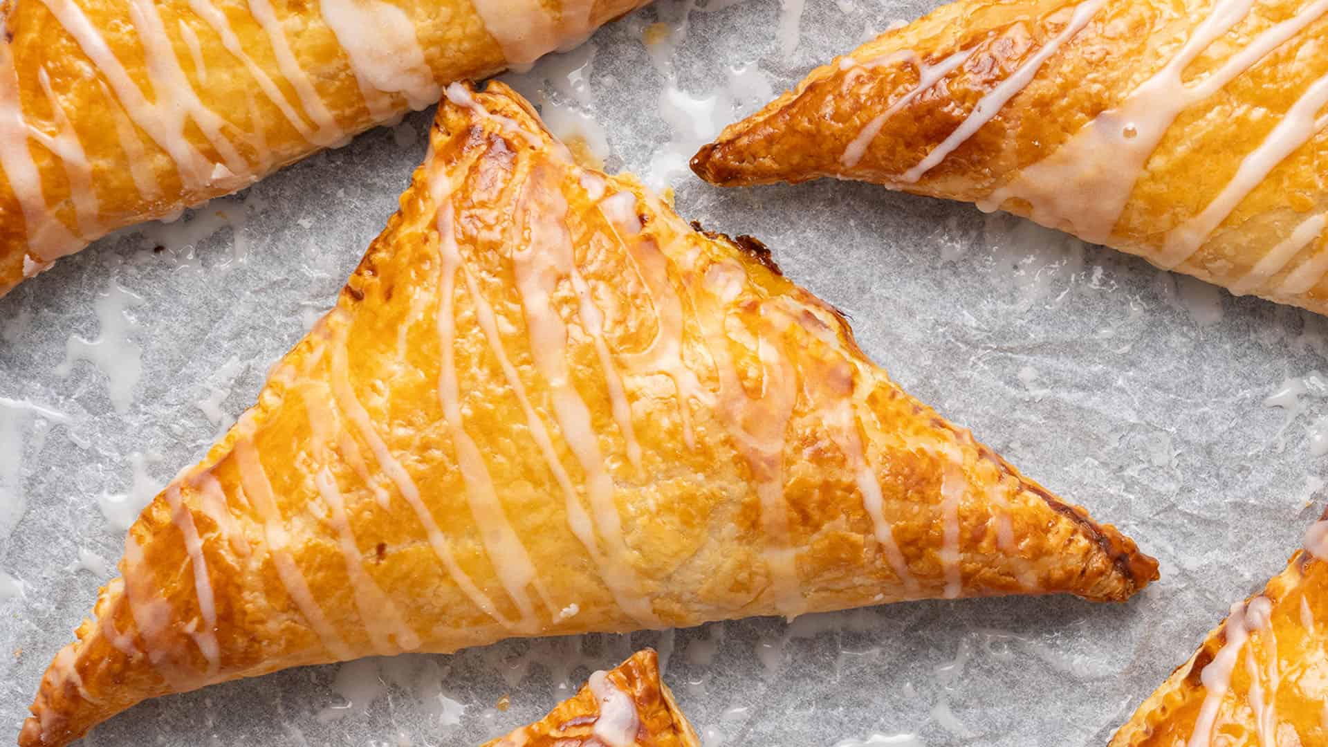 Puff Pastry pumpkin turnover on a baking sheet.