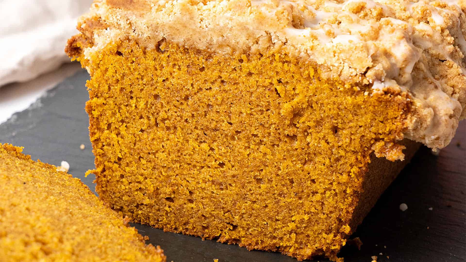 Pumpkin streusel bread on a cutting board.
