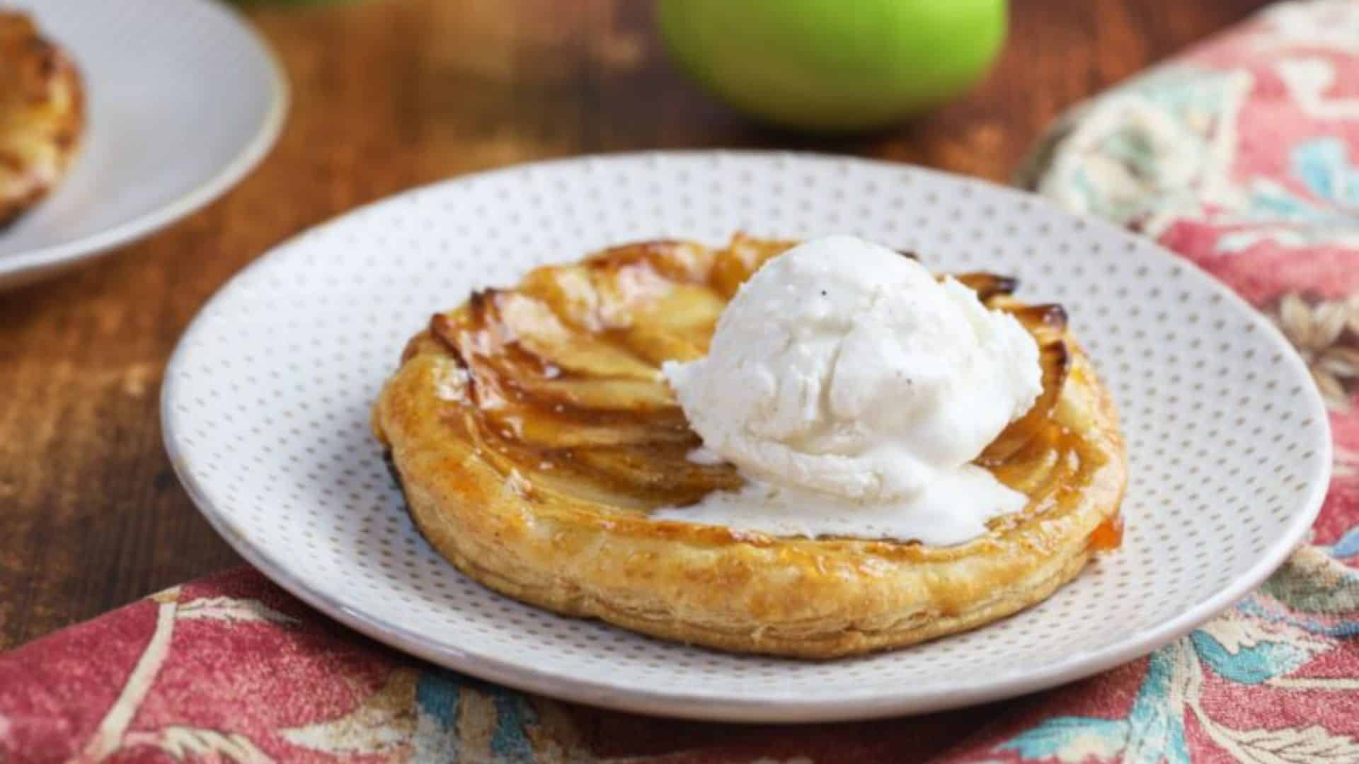 Apple tarts topped with ice cream.