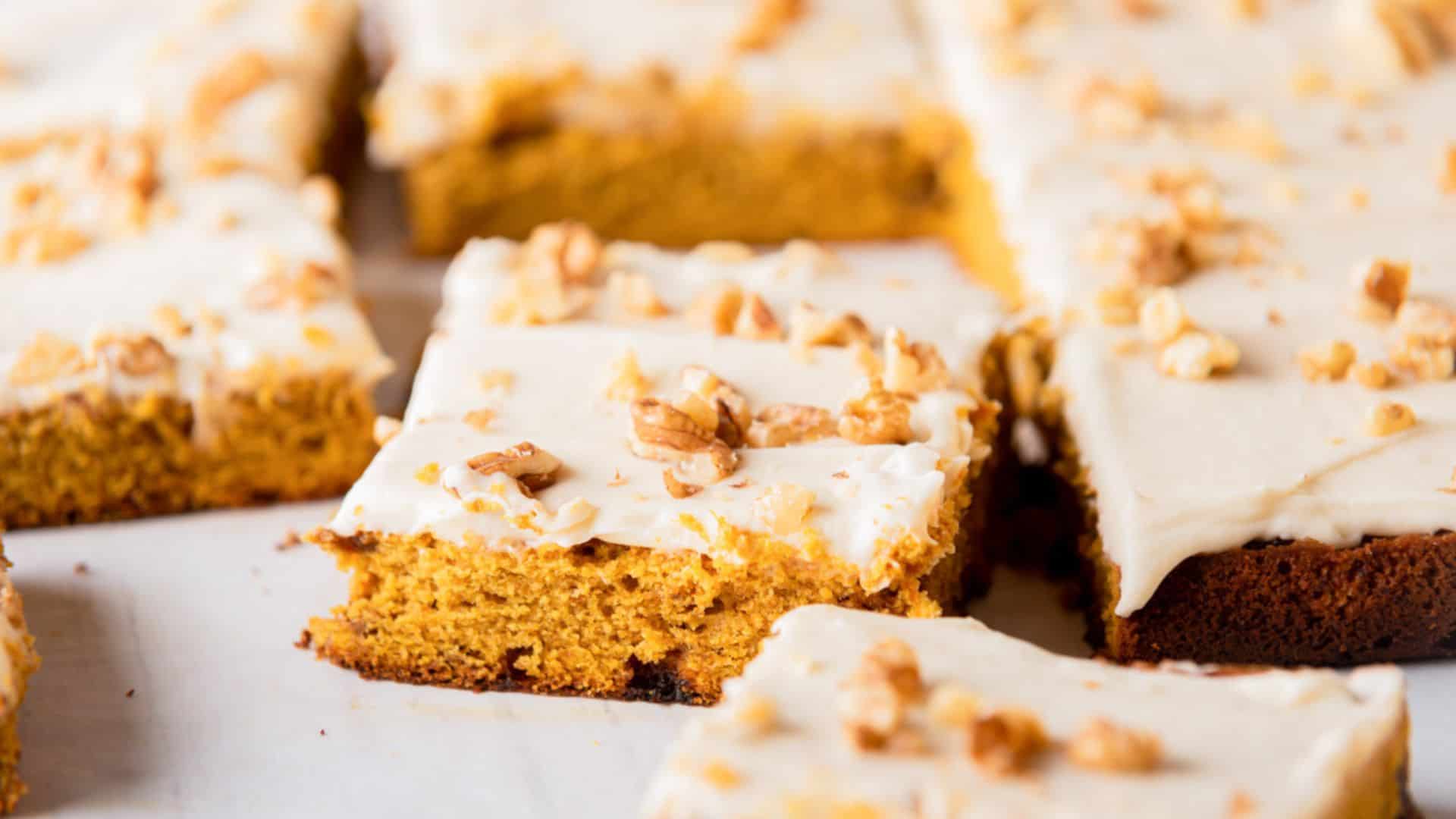 Slices of pumpkin sheet cake on a plate.