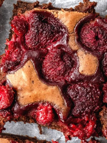 Raspberry brownies on a baking sheet.