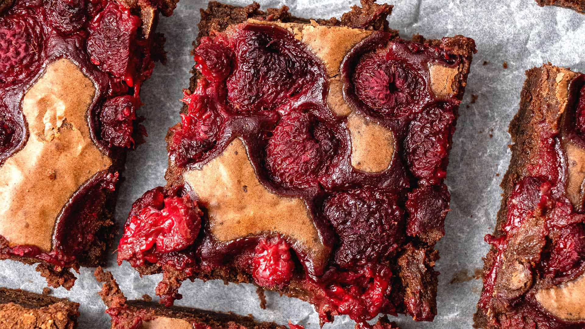 Raspberry brownies on a baking sheet.