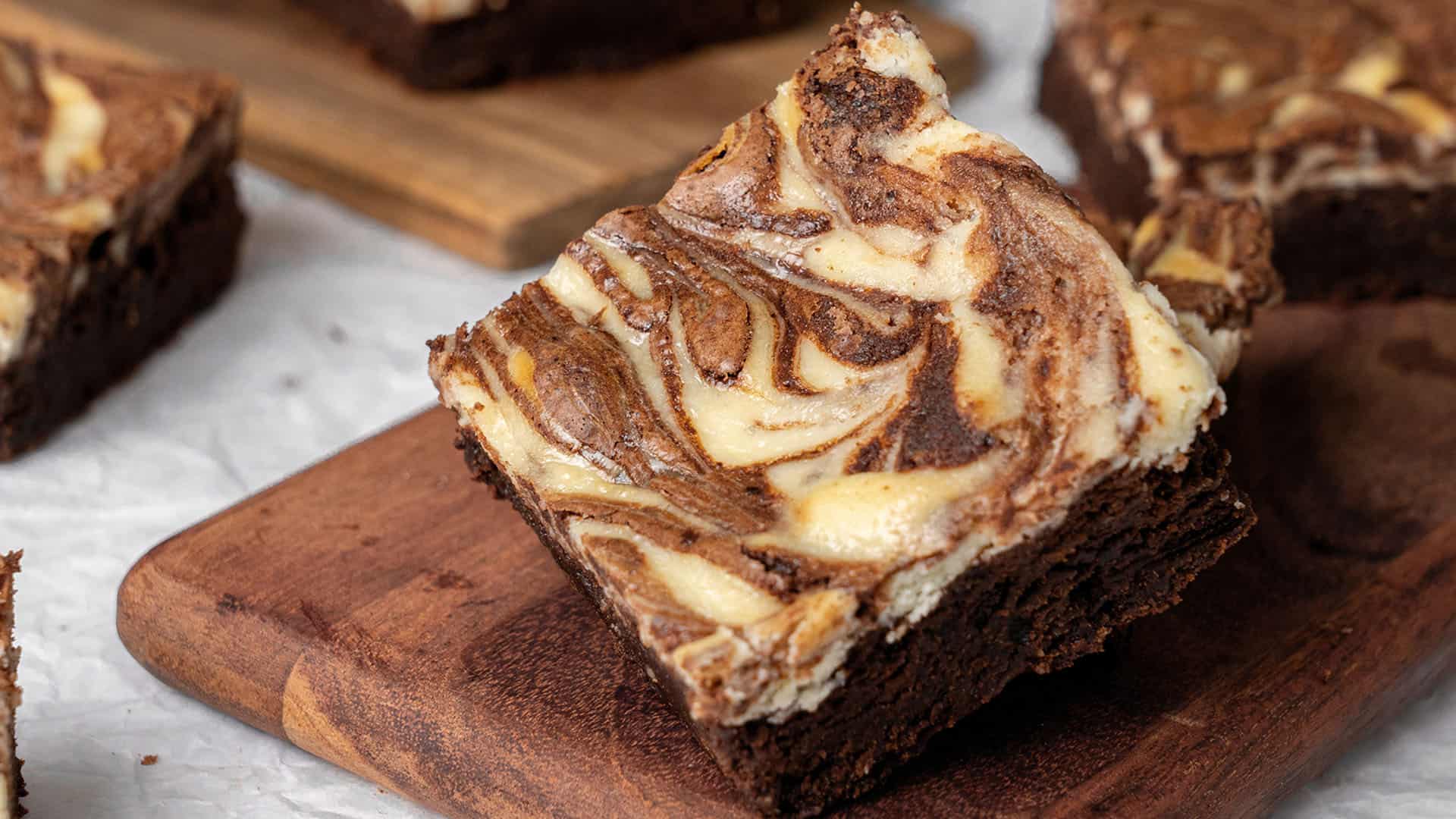 Cheesecake Brownies on a cutting board.