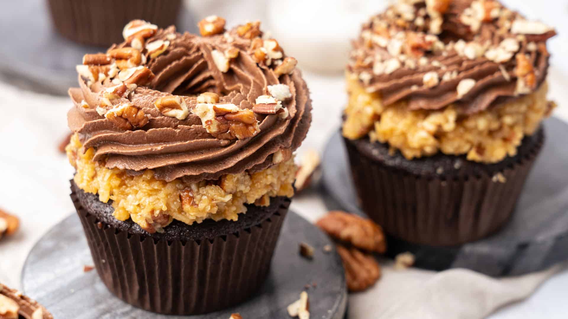 German chocolate cupcakes on a cutting board.