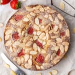Almond strawberry cake on a baking paper.