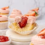 a strawberry filled cupcakes on a plate.