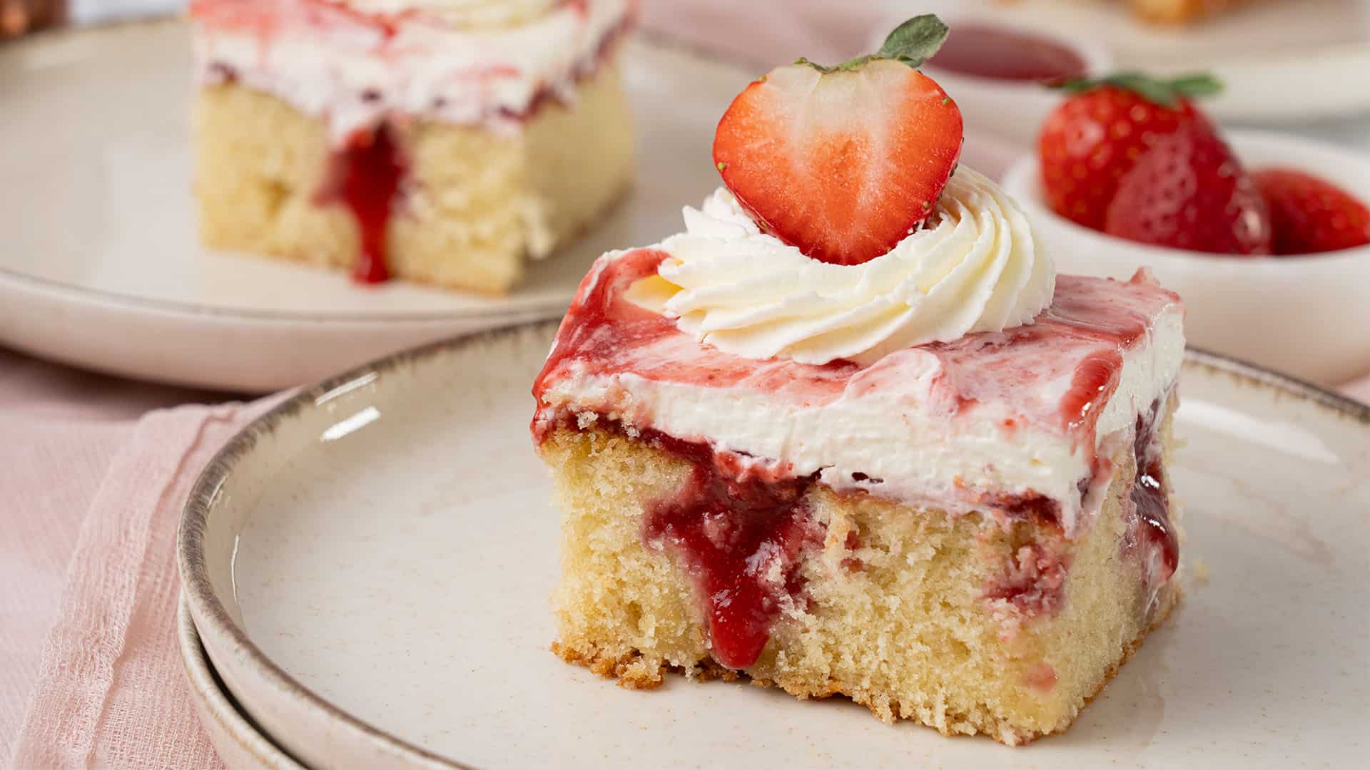 A slice of strawberry poke cake.