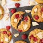 White chocolate raspberry cookies on a cutting board.