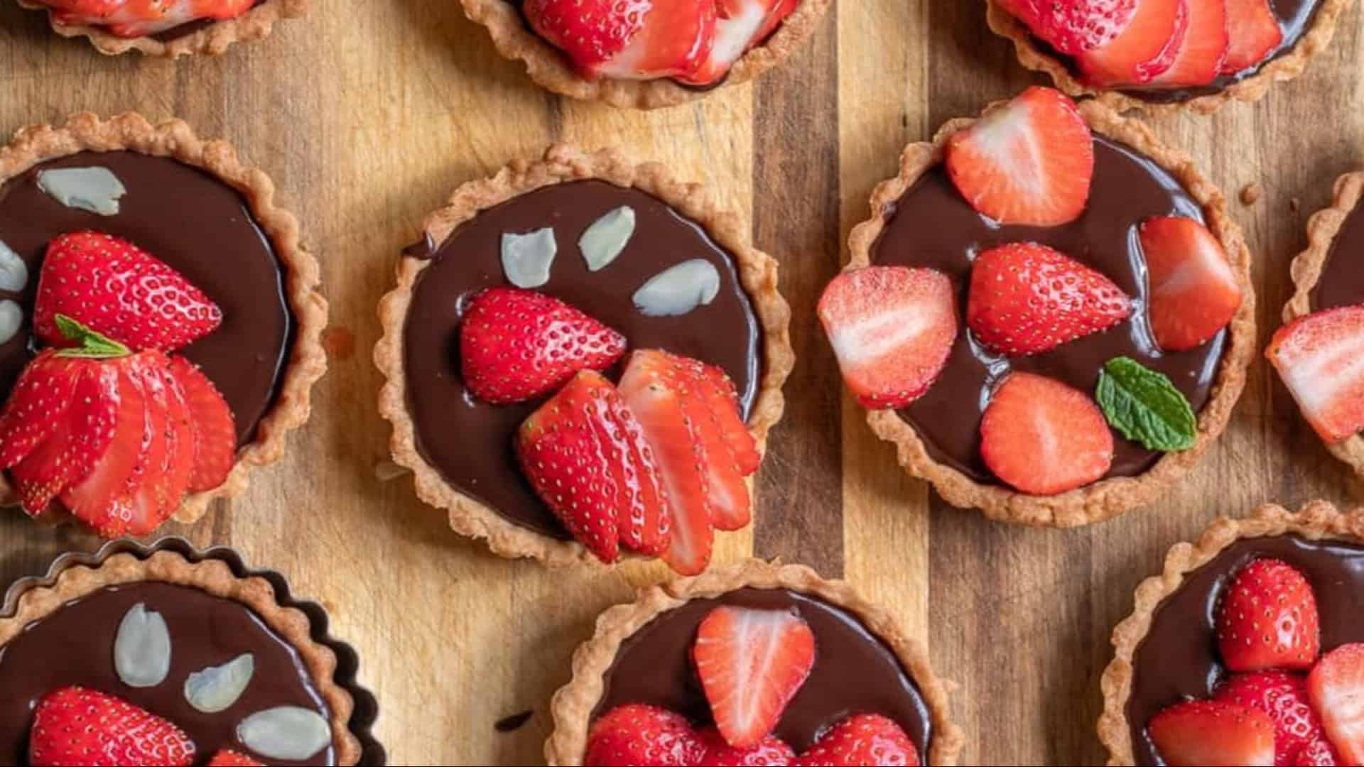 tarts filled with chocolate ganache and strawberries