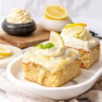 A slice of lemon poke cake on a plate.