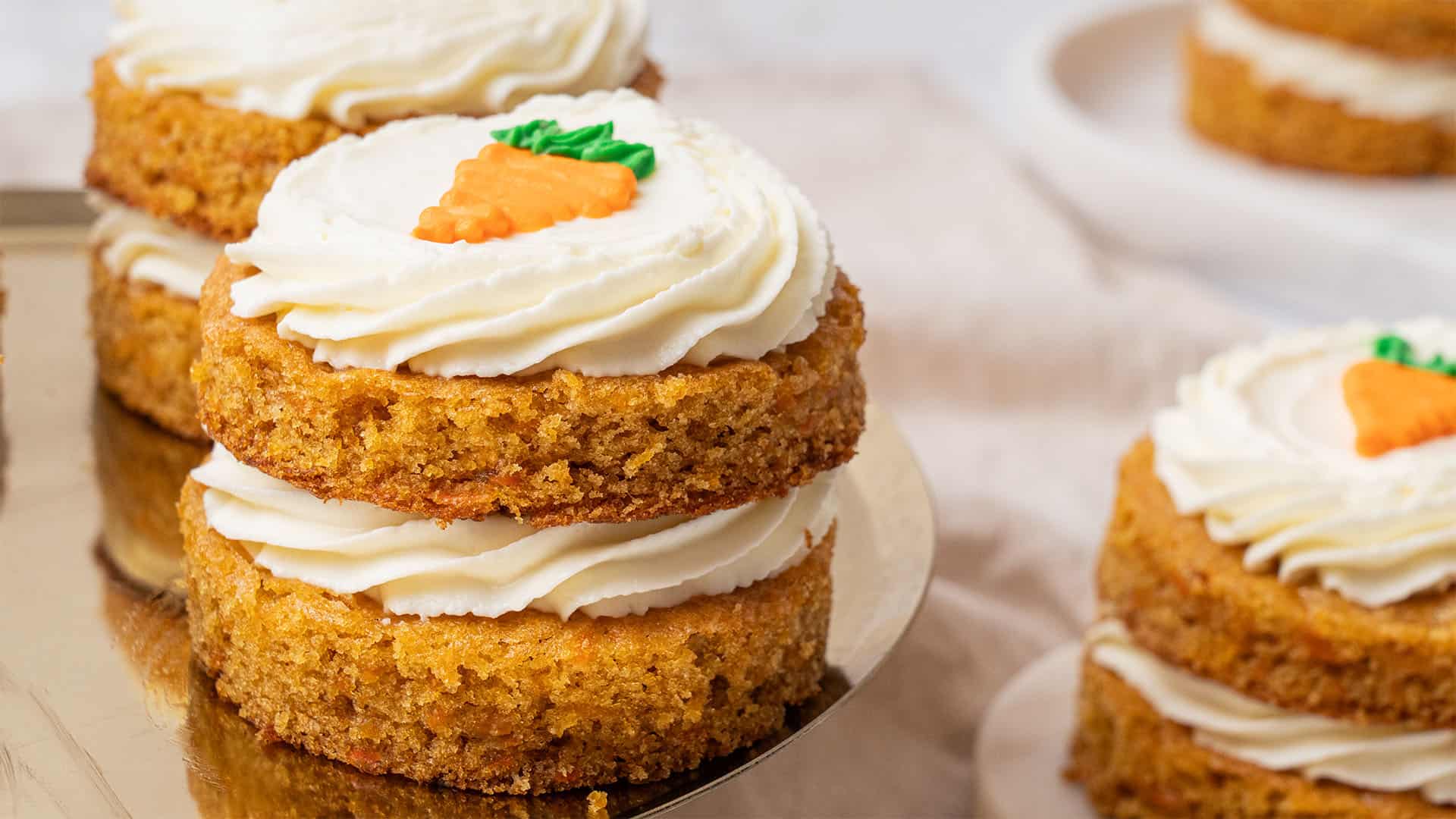 A few mini carrot cakes on a plate.