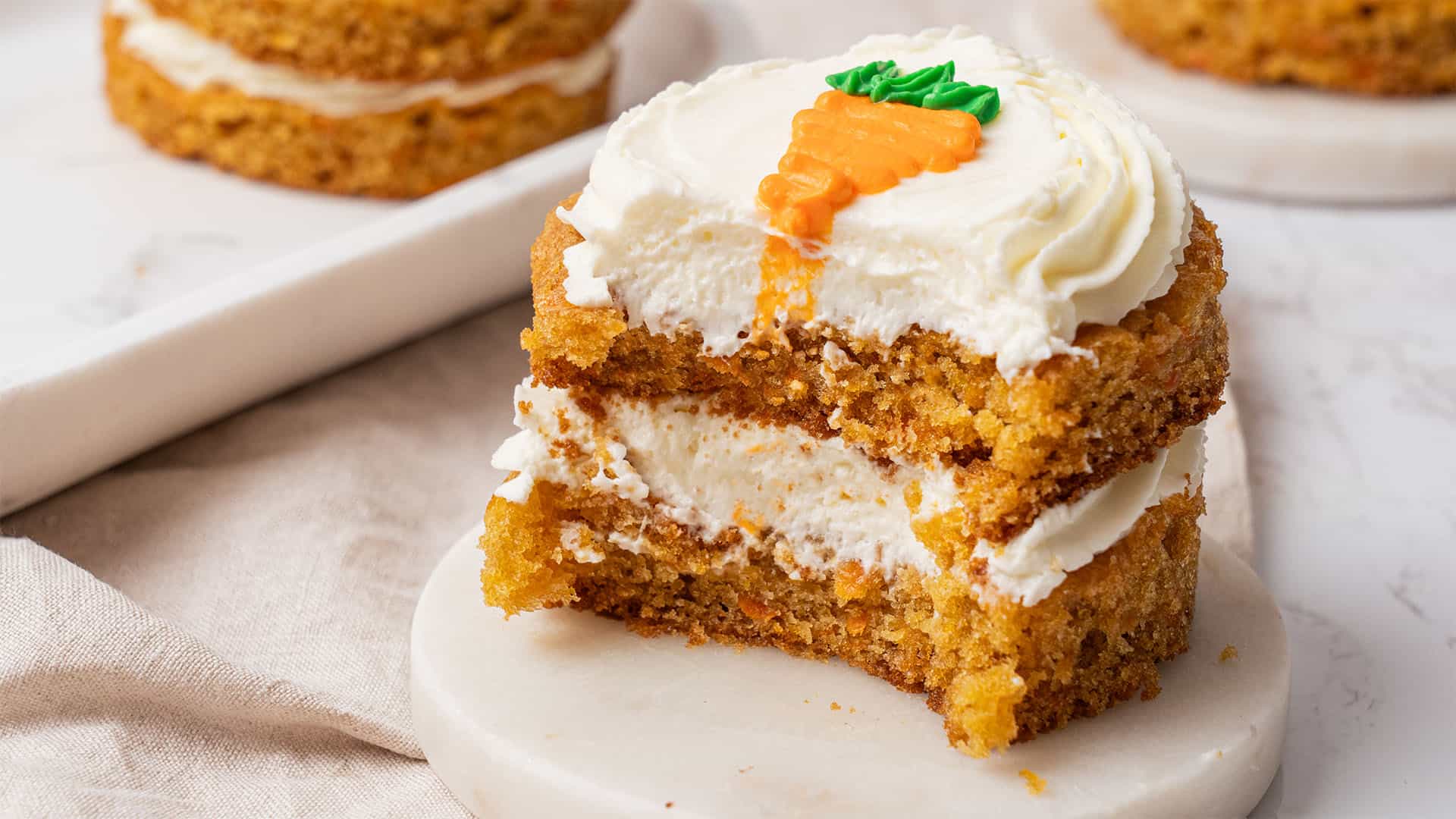 A mini carrot cake on a plate.
