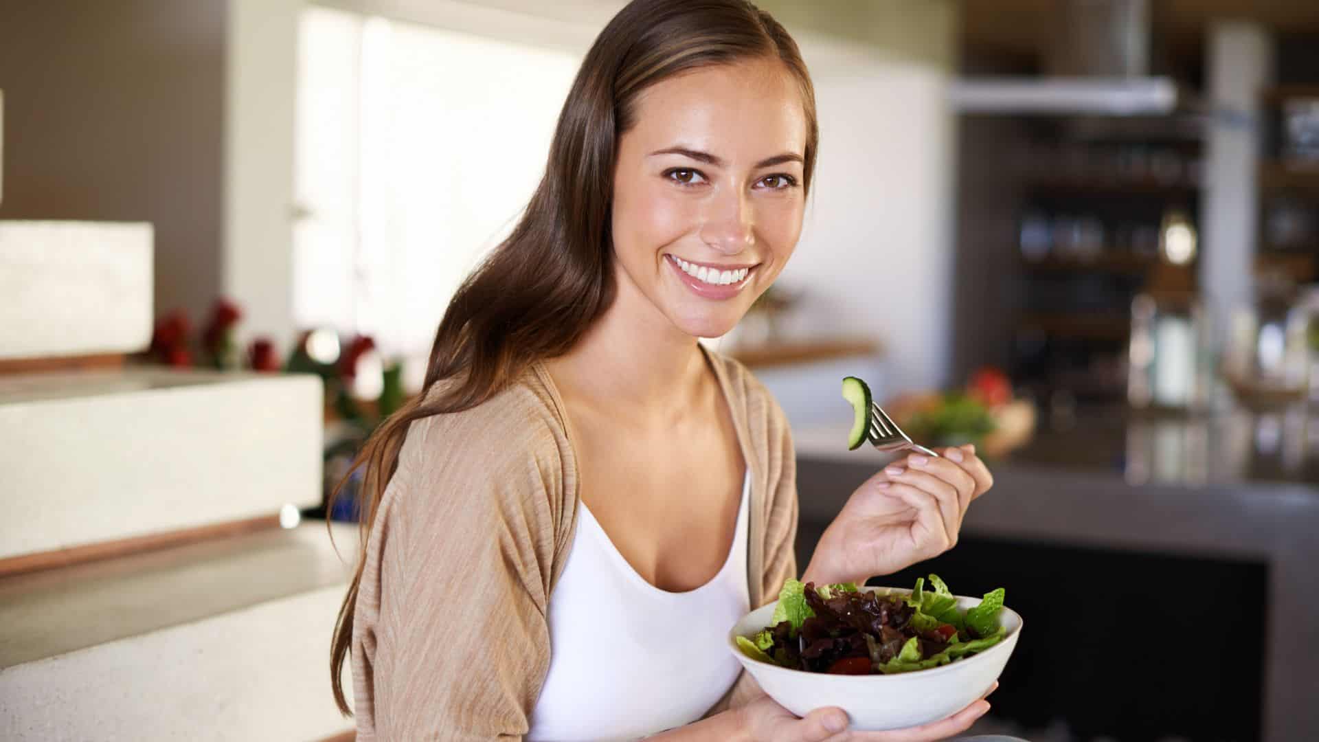Woman eating salad.