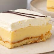 A slice of Cream Puff Cake on a plate.