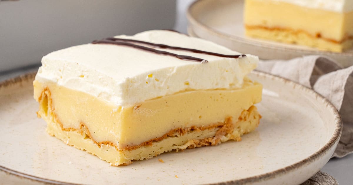 A slice of Cream Puff Cake on a plate.