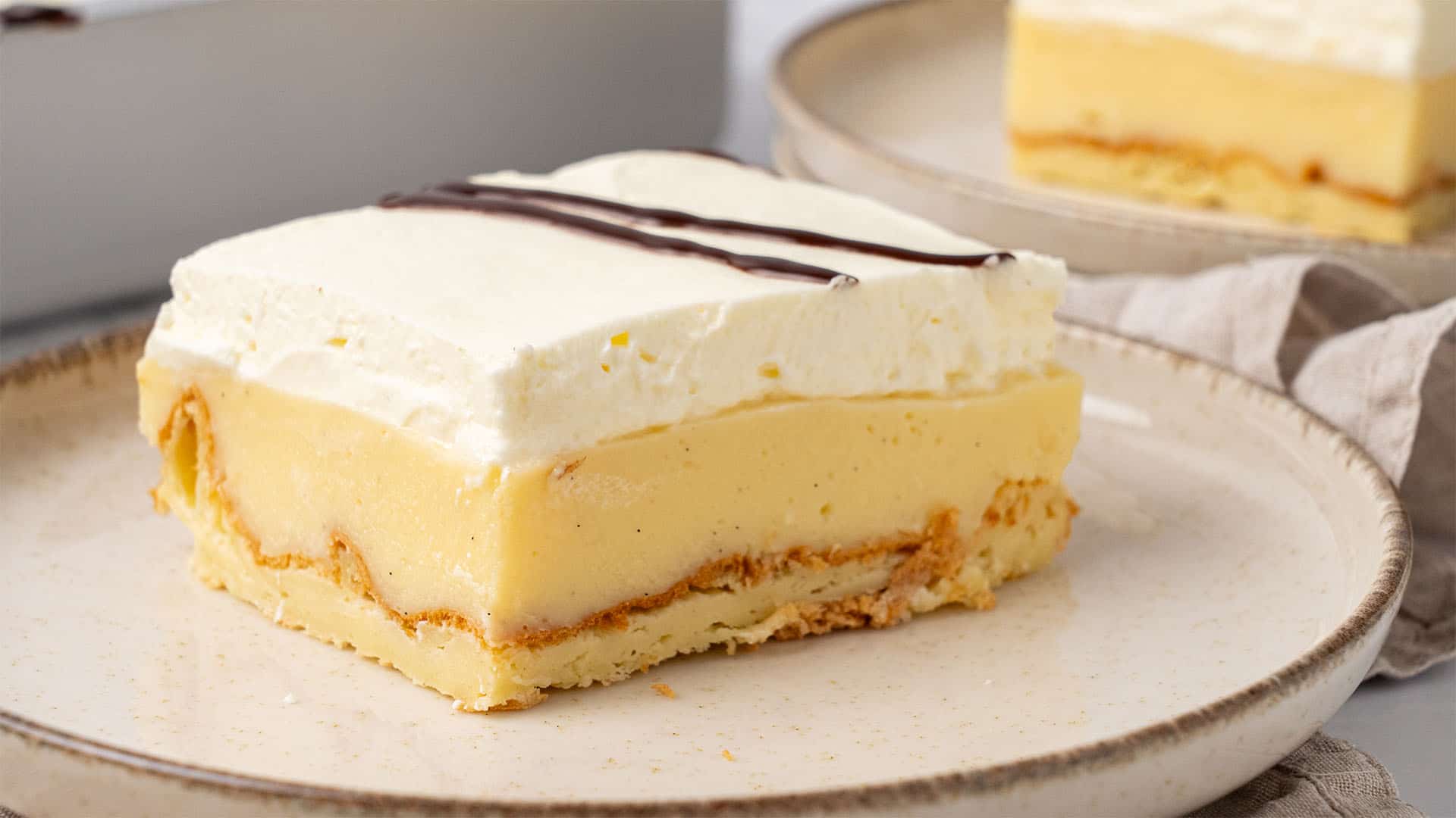 A slice of Cream Puff Cake on a plate.