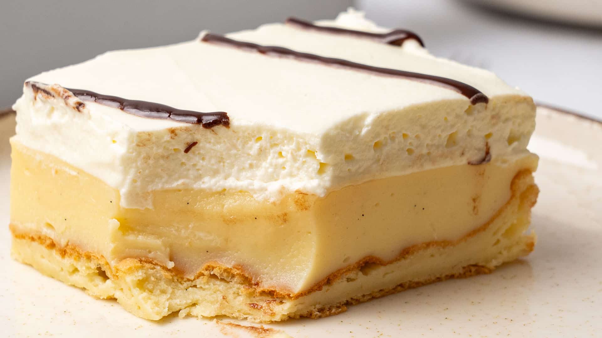 A slice of Cream Puff Cake on a plate.