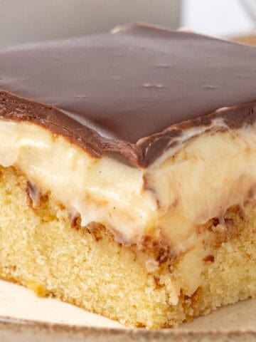 A slice of Boston cream poke cake.