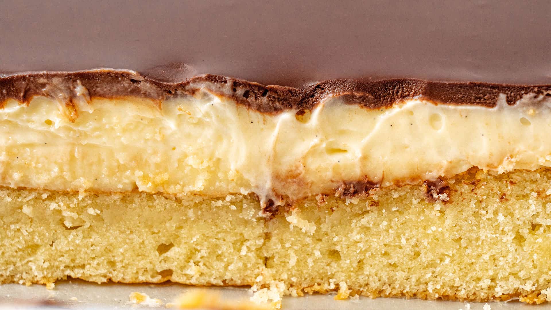 A slice of Boston cream poke cake.