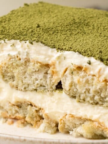 a slice of matcha tiramisu on a plate.