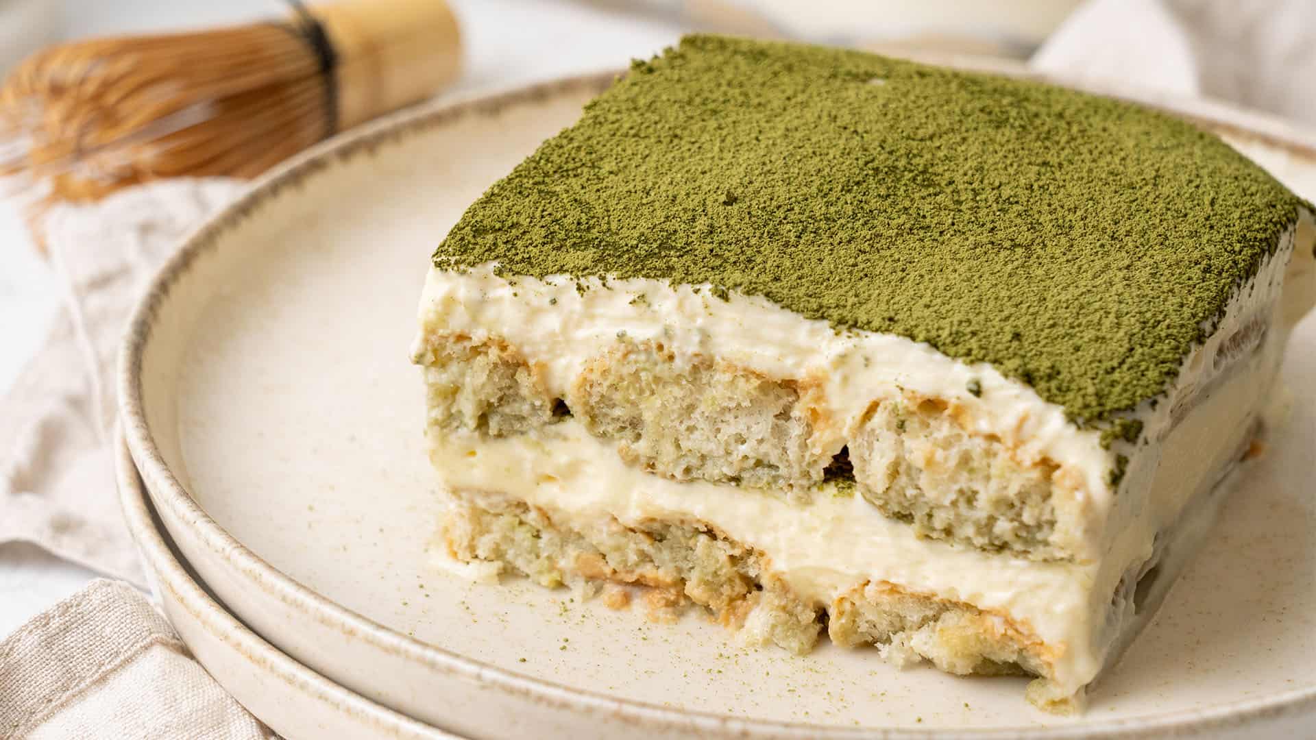 a slice of matcha tiramisu on a plate.