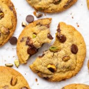 Pistachio cookies on a cutting board.