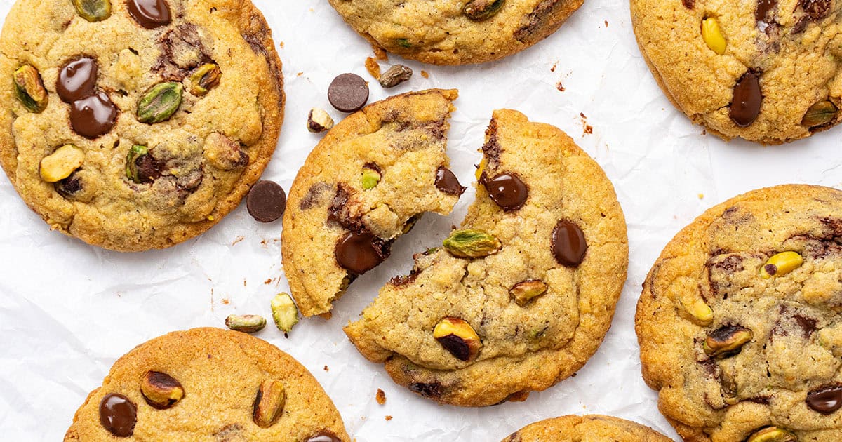 Pistachio cookies on a cutting board.