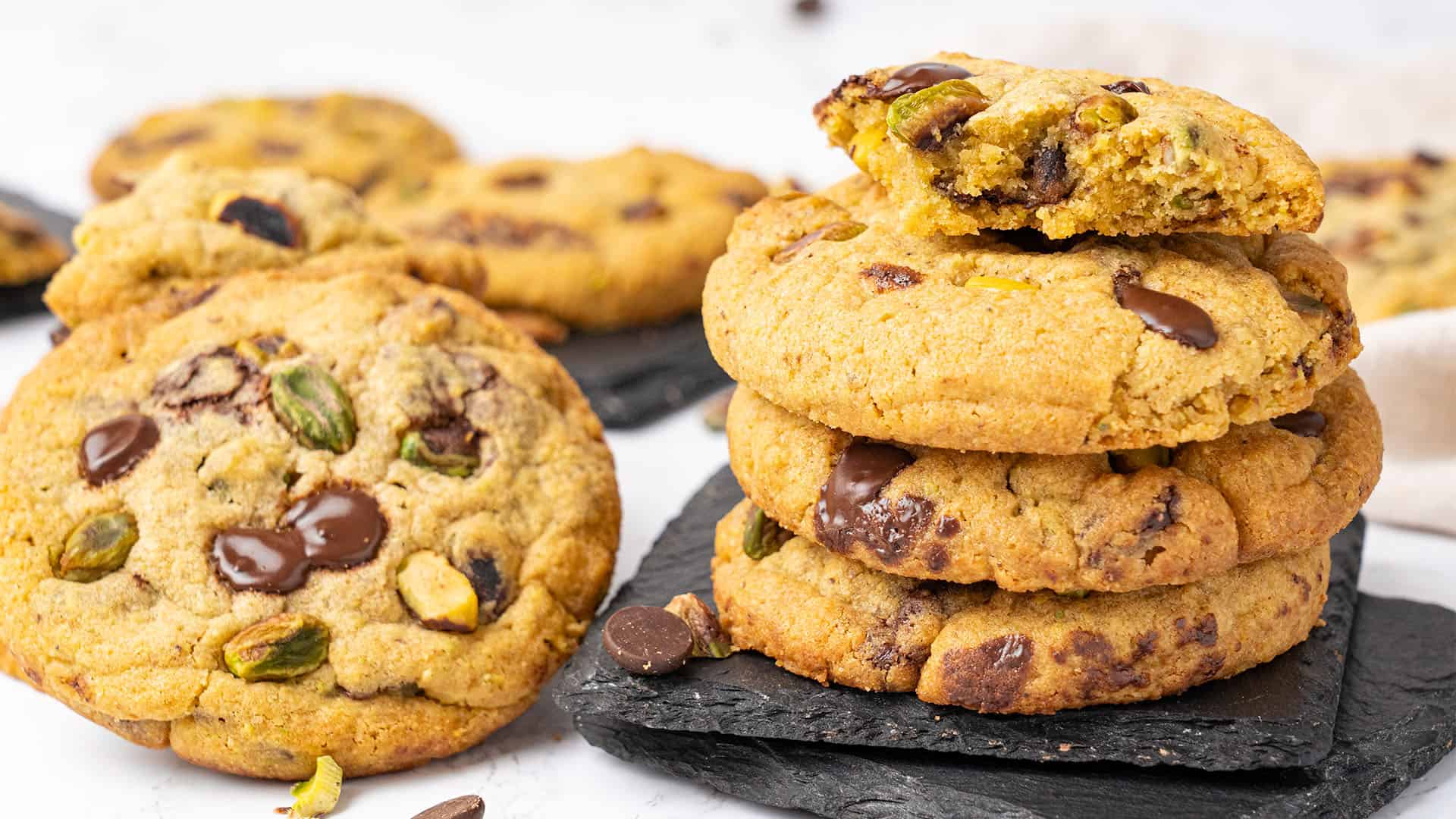 Pistachio cookies on a cutting board.