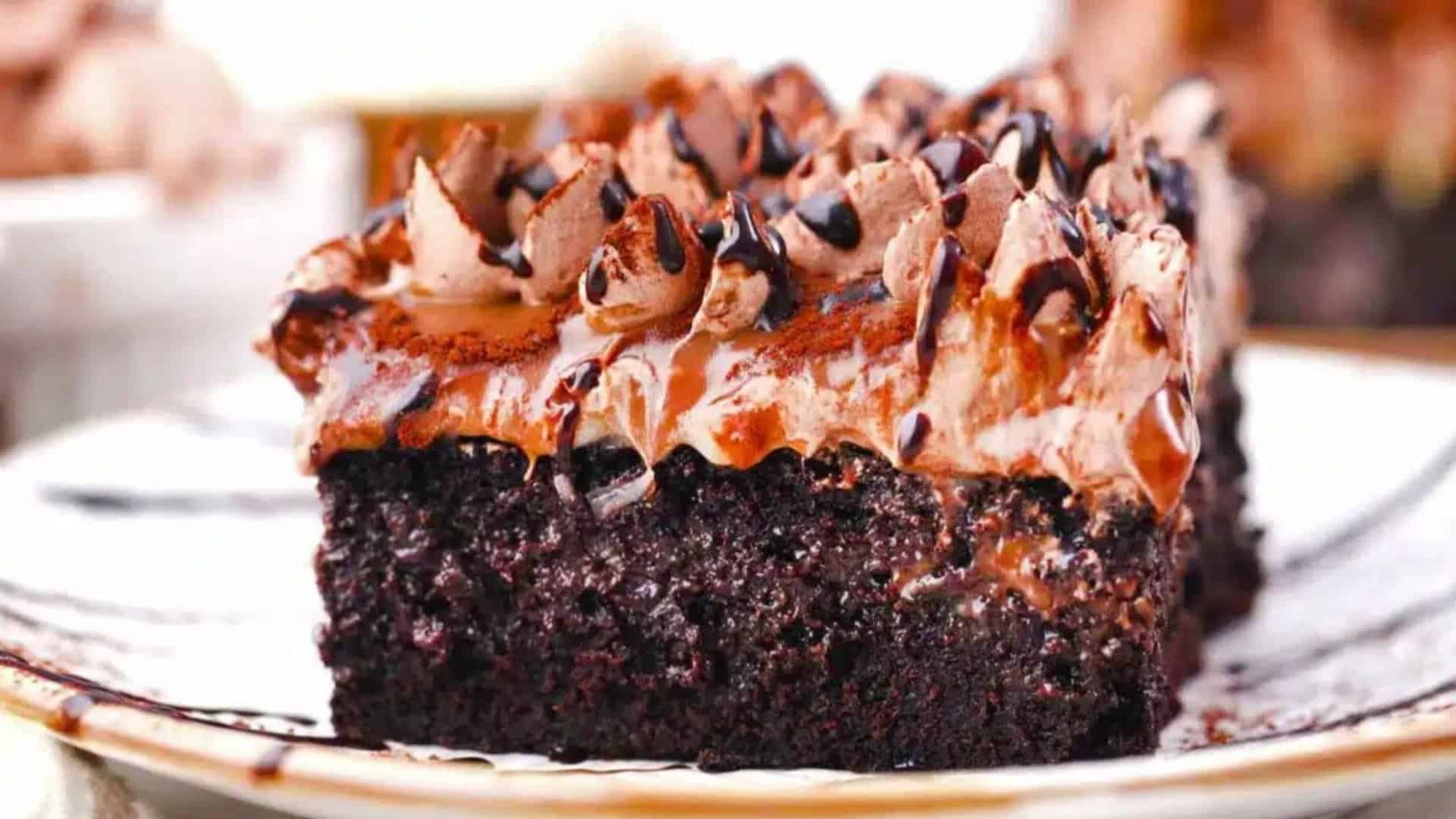 slice of german chocolate poke cake with chocolate drizzle