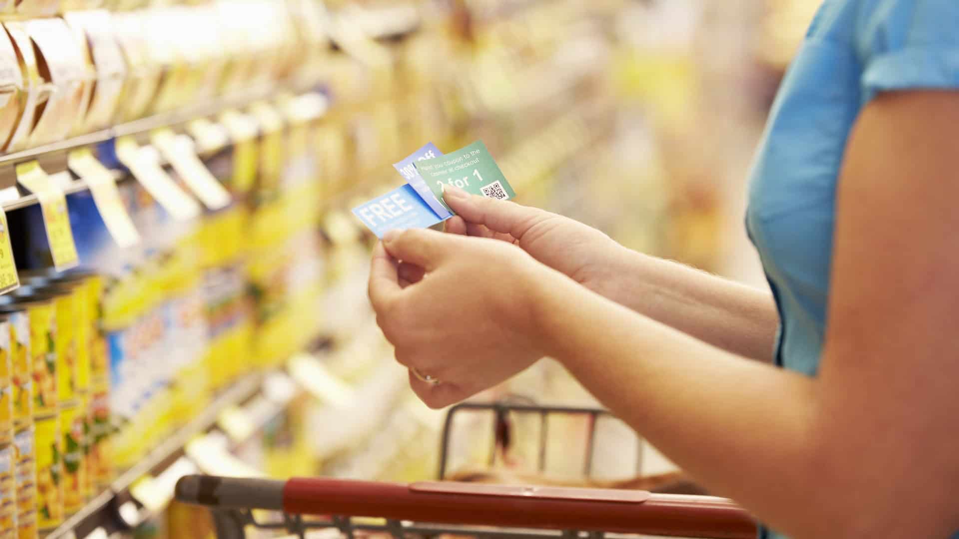 looking at coupons in the grocery store