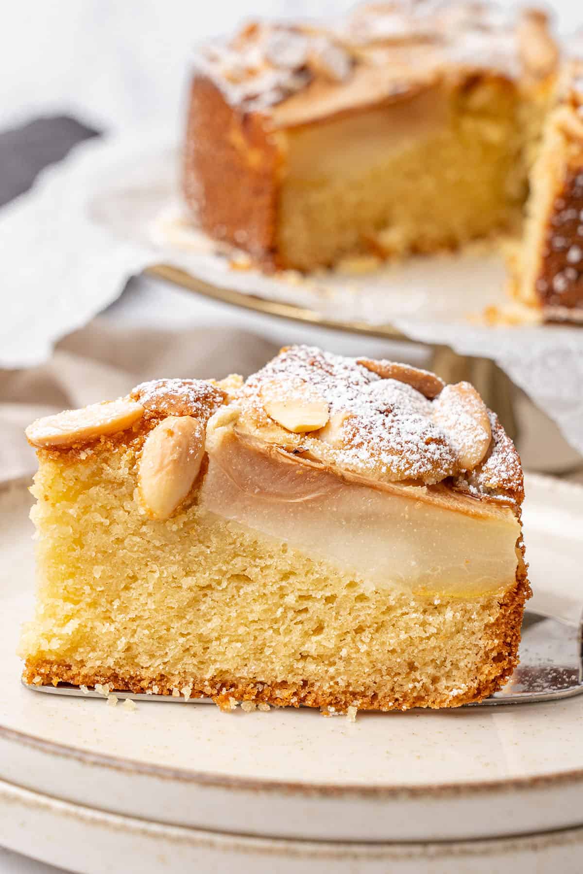 a slice of Pear Almond Cake on a plate.