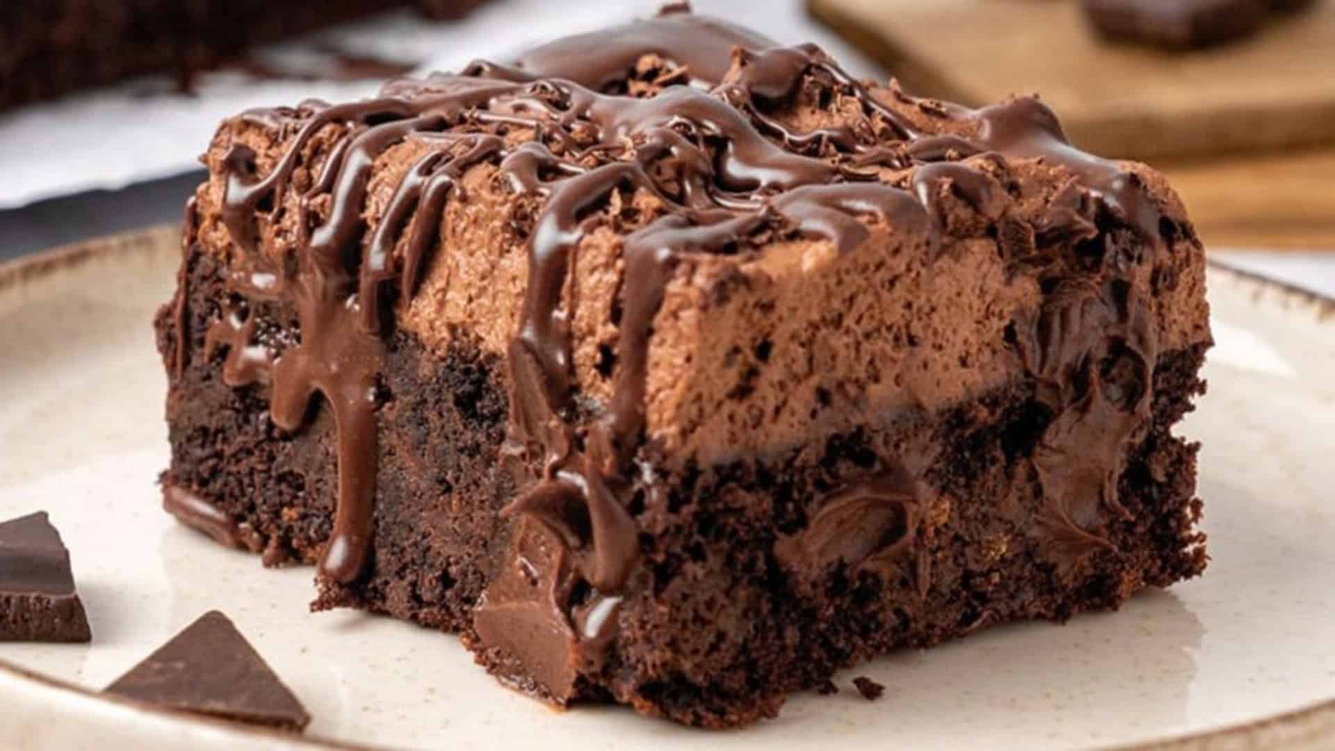 slice of chocolate poke cake with chocolate drizzle