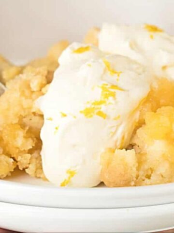 lemon dump cobbler on a plate with whipped cream