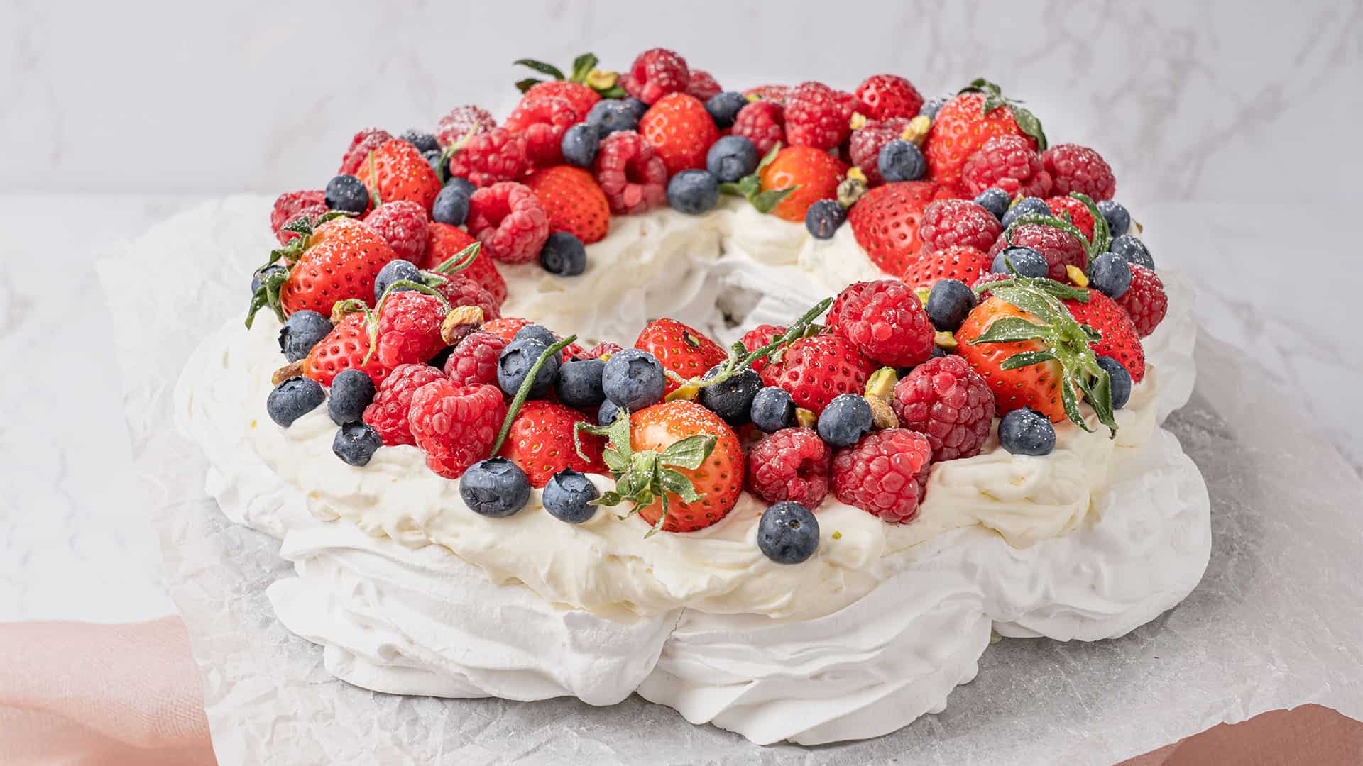 Pavlova wreath on a cake stand.