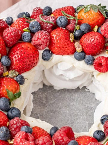 Pavlova wreath on a cake stand.
