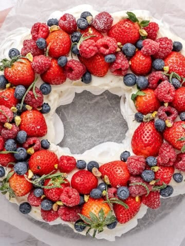 Pavlova wreath on a cake stand.