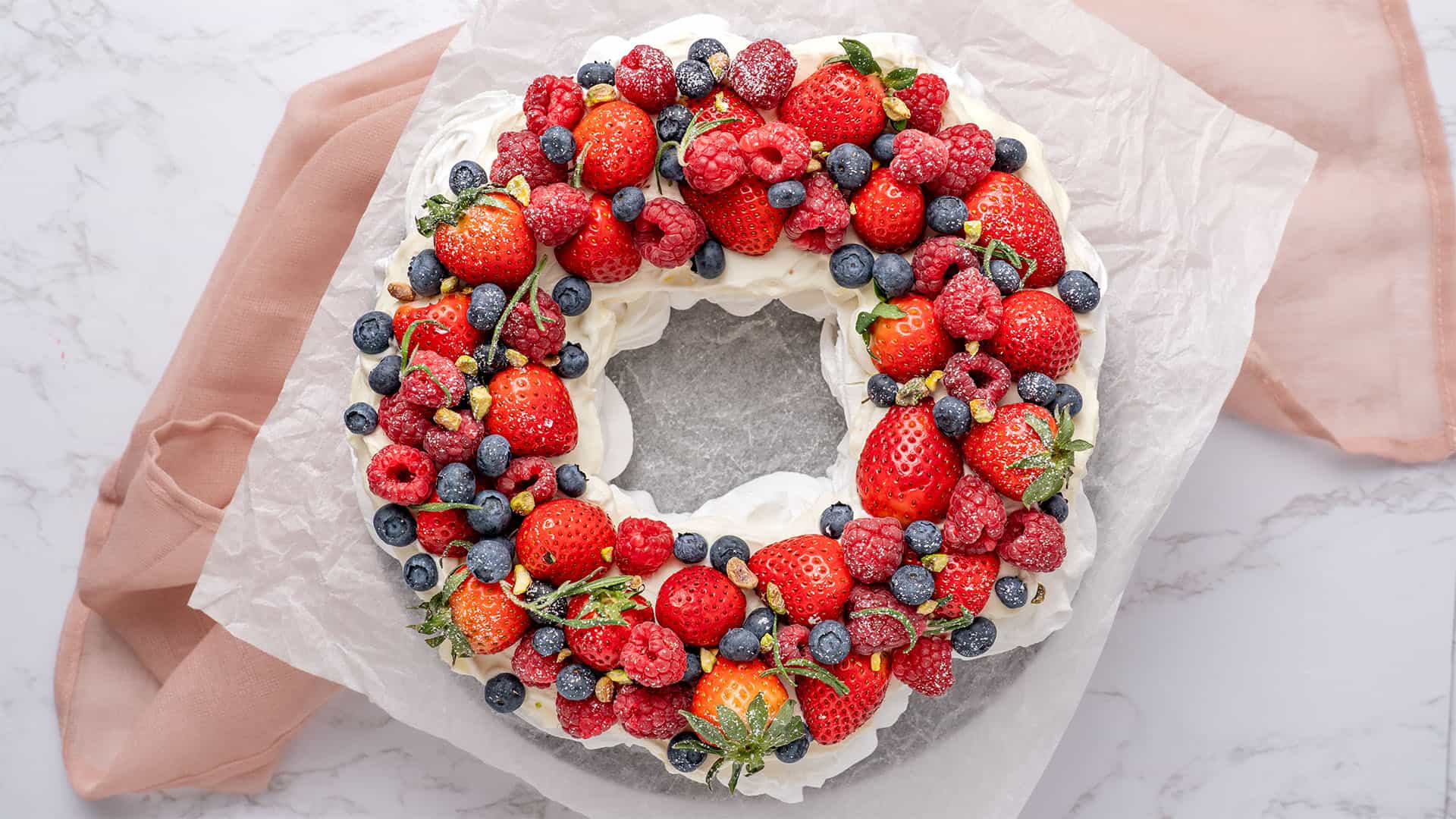 Pavlova wreath on a cake stand.