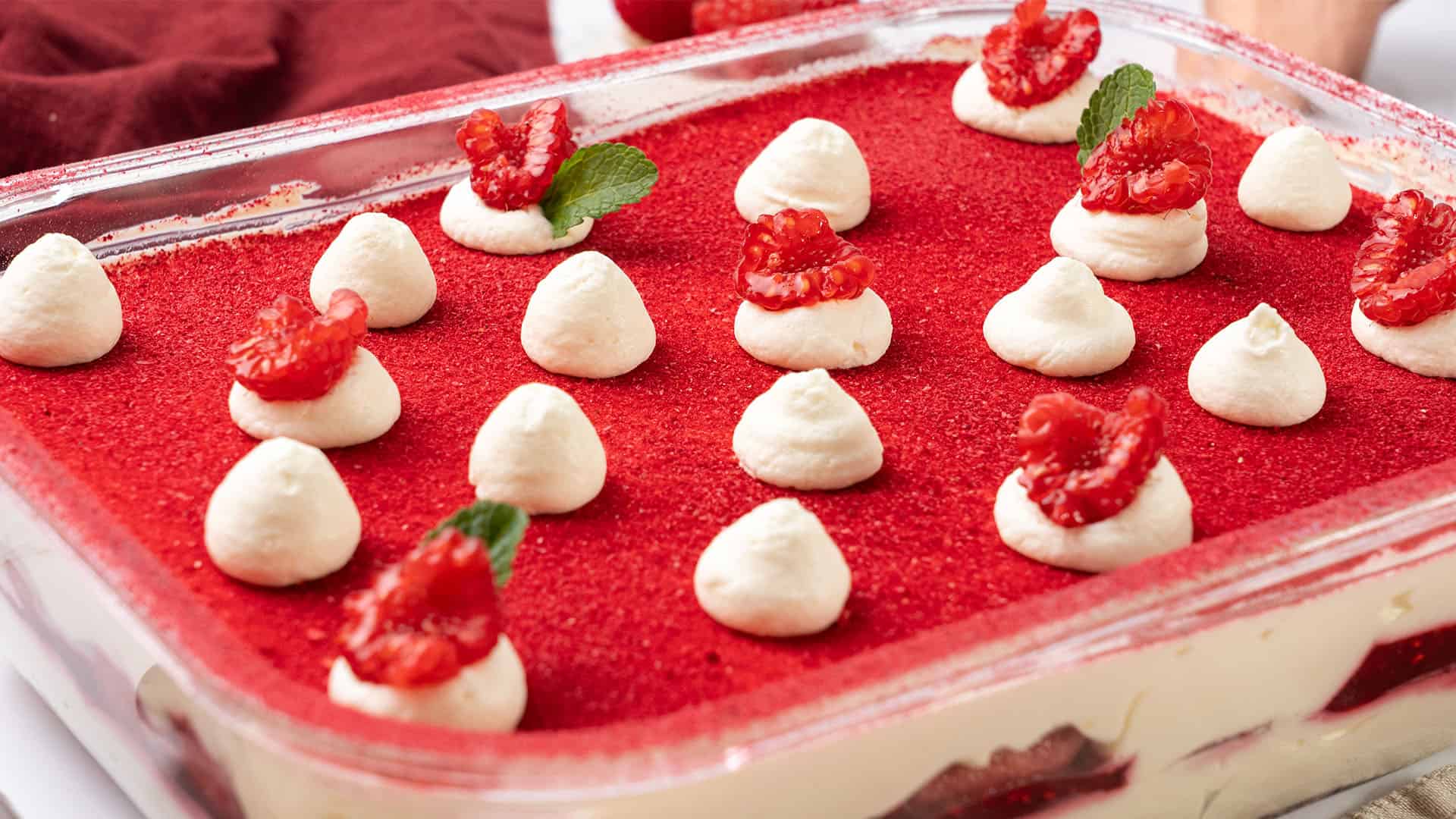 Raspberry tiramisu in a food container.