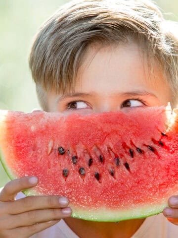 kid eating watermelon.