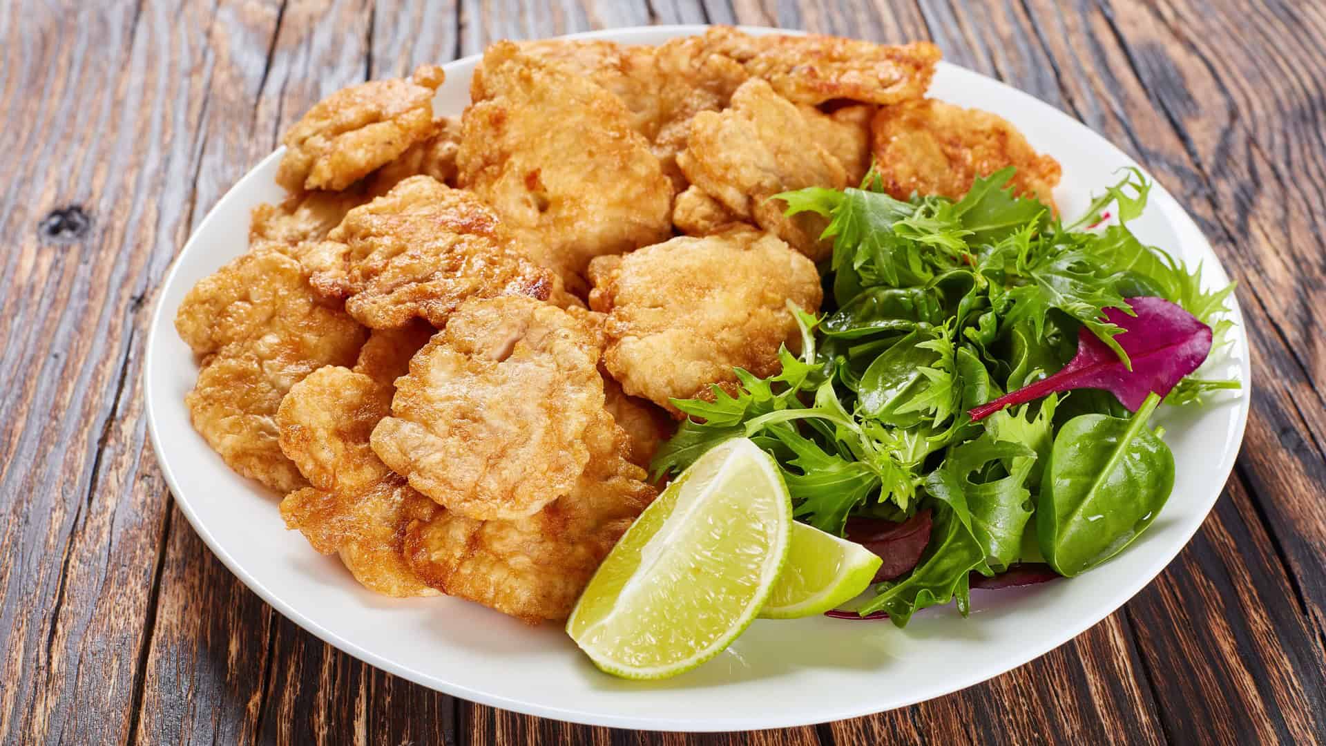 deep fried lamb brain on a plate with salad
