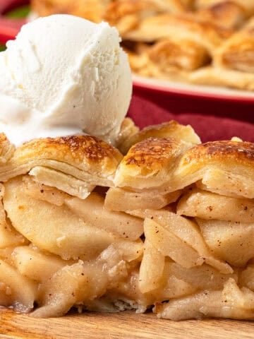 a slice of apple pie with a scoop of ice cream.