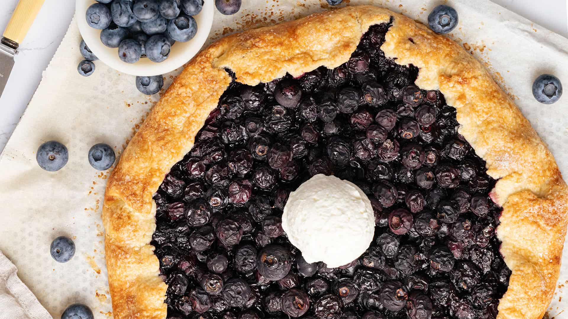 Blueberry galette with a scoop of ice cream.