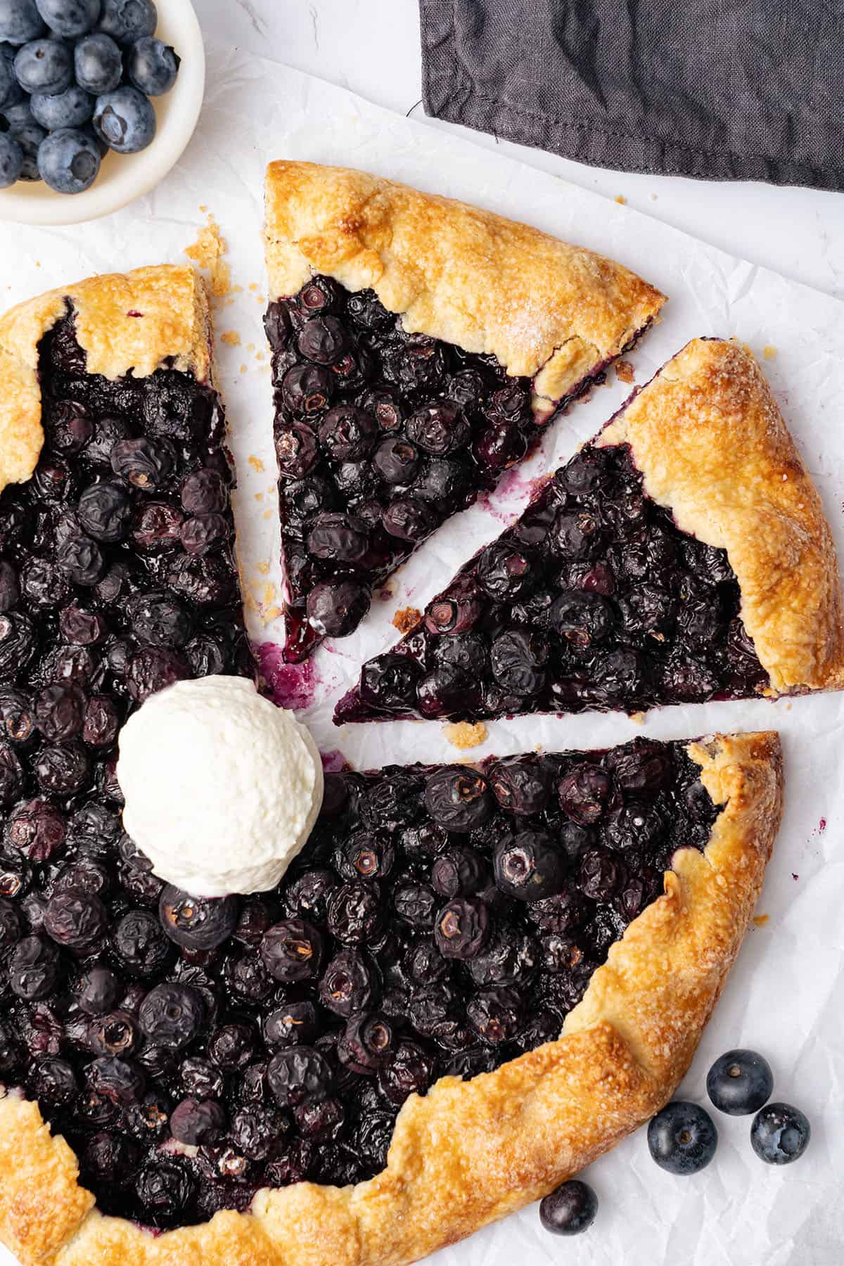 Blueberry galette with a scoop of ice cream.
