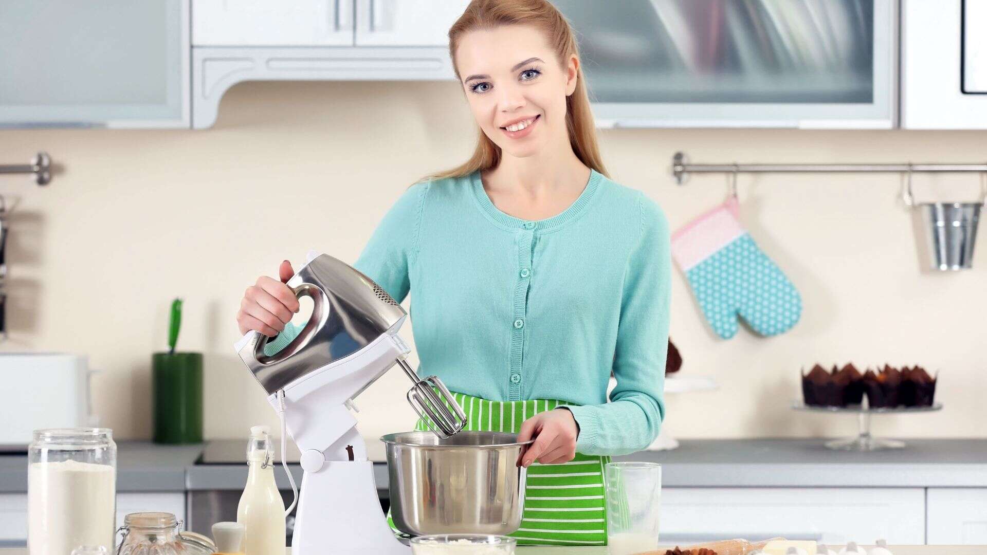 Woman Using a Electronic Mixer to Make a Dough